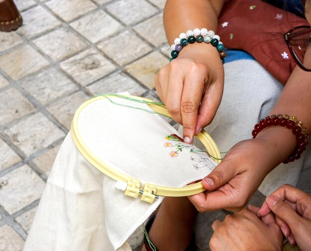 Artisan hands holding embroidered fabric